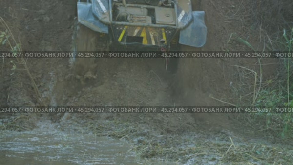 The off-road buggy goes up a steep slope. The wheels are literally digging into the ground. All four wheels are tugging, throwing piles of soil out from under them. Slow motion. Стоковое видео, видеограф Воловодов Владимир / Фотобанк Лори