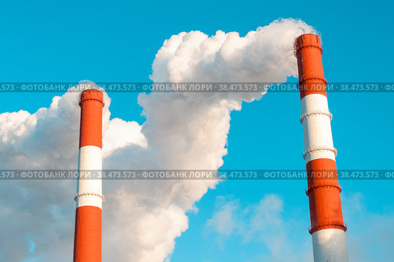 The pipe of the thermal power plant on the background of the blue sky. The concept of ecology and environmental protection. Стоковое фото, фотограф Ярославский Максим / Фотобанк Лори