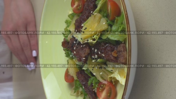 The woman sprinkles the salad with sesame seeds. Vertical video. Close-up. Concept of Healthy Lifestyle and Healthy Nutrition. Стоковое видео, видеограф Сахарова Мария Юрьевна / Фотобанк Лори