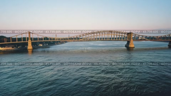 There exists a magnificent bridge that elegantly spans over a serene body of water nearby. Стоковое AI-видео, аниматор Юрий Поздников / Фотобанк Лори