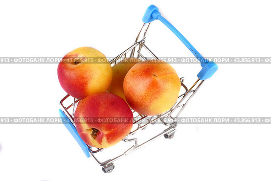 Three ripe red smooth apricots in a shopping basket on a white background. View from above. Стоковое фото, фотограф Ярославский Максим / Фотобанк Лори
