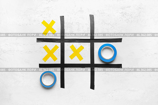 Tic-tac-toe game made of adhesive tapes on white background. Стоковое фото, фотограф Pixel_shot / Фотобанк Лори