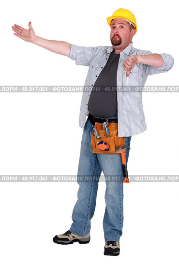 Tradesman pointing to an object and giving the thumb’s down. Стоковое фото, агентство Ingram Publishing / Фотобанк Лори