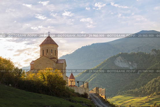 Traditional Georgian church on a background of mountain scenery. St.Nicholas Church in Mestia, Upper Svaneti, Georgia (2018 год). Стоковое фото, фотограф Юлия Бабкина / Фотобанк Лори