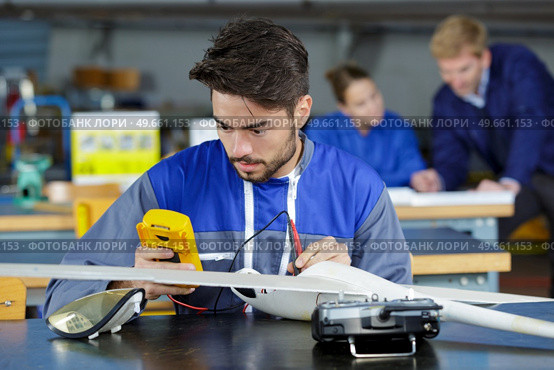 trainee aircraft engineer using a multimeter. Стоковое фото, агентство Ingram Publishing / Фотобанк Лори