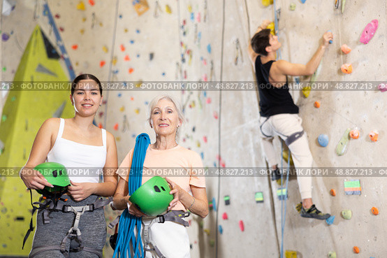 two active female marathon participants are standing in climbing hall. Стоковое фото, фотограф Яков Филимонов / Фотобанк Лори