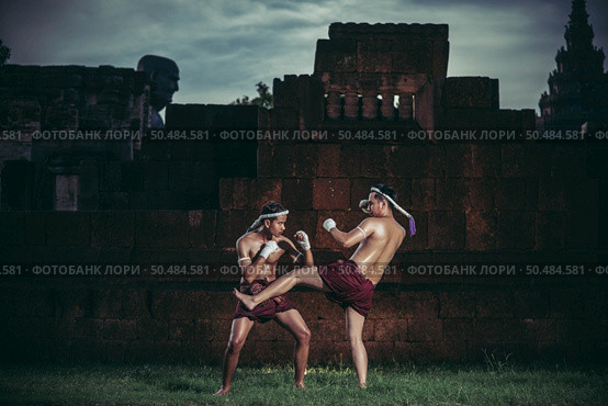 Two boxers fight with the martial arts of Muay Thai. Selective focus. Стоковое фото, агентство Ingram Publishing / Фотобанк Лори
