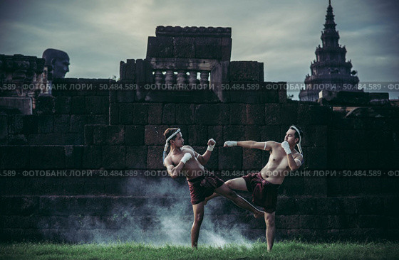 Two boxers fight with the martial arts of Muay Thai. Selective focus. Стоковое фото, агентство Ingram Publishing / Фотобанк Лори