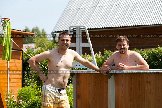 Two brothers pose near their backyard pool. Стоковое фото, фотограф Андрей Аркуша / Фотобанк Лори