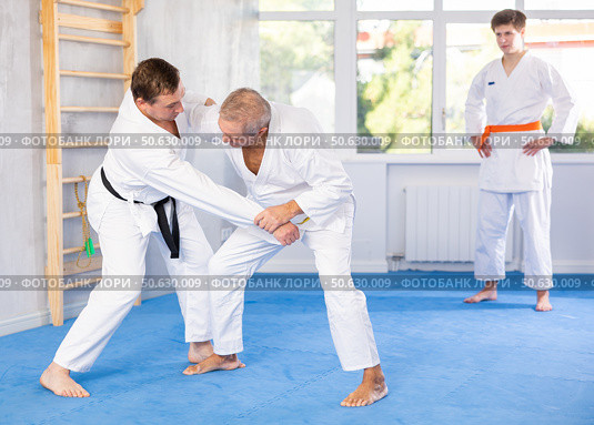 Two experienced male karatekas practicing techniques in friendly kumite. Стоковое фото, фотограф Яков Филимонов / Фотобанк Лори