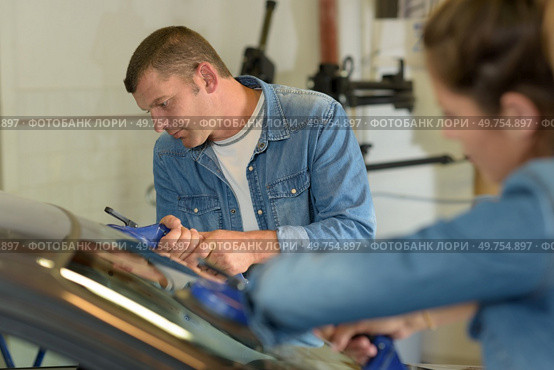 two glaziers removing car windshield. Стоковое фото, агентство Ingram Publishing / Фотобанк Лори