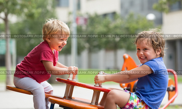 Two happy little sisters on teetering board. Стоковое фото, фотограф Яков Филимонов / Фотобанк Лори