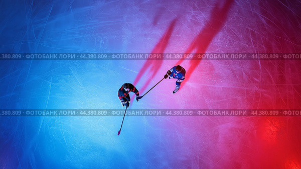 Two hockey players in action under colorful lighting on the ice rink during a competitive match at night. Стоковое AI-изображение, AI-художник Сергей Толмачёв / Фотобанк Лори