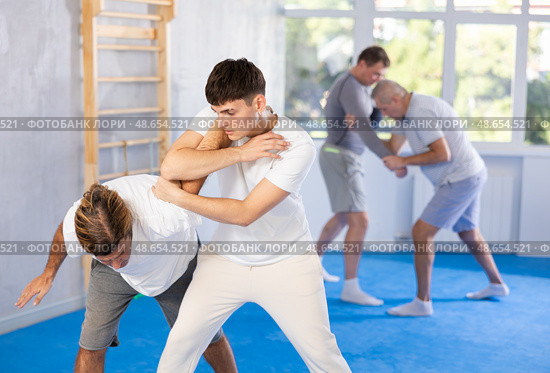 Two men training judo technique in studio. Стоковое фото, фотограф Яков Филимонов / Фотобанк Лори