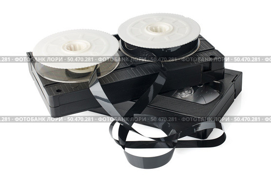 Two videotapes and reel on  white reflective background. Стоковое фото, агентство Ingram Publishing / Фотобанк Лори