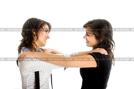 Two young beautiful sisters having fun isolated on white - This models are true twins. Стоковое фото, агентство Ingram Publishing / Фотобанк Лори