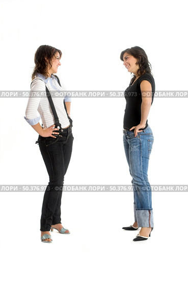 Two young beautiful sisters having fun isolated on white - This models are true twins. Стоковое фото, агентство Ingram Publishing / Фотобанк Лори