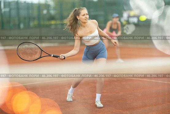 Two young women playing doubles tennis. Стоковое фото, фотограф Яков Филимонов / Фотобанк Лори