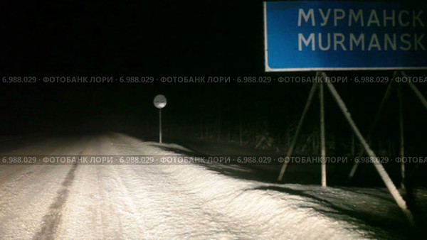 Указатель направления и километража до Мурманска в свете фар ночное время. Автотрасса Кола в зимнее время года. Стоковое видео, видеограф Кекяляйнен Андрей / Фотобанк Лори