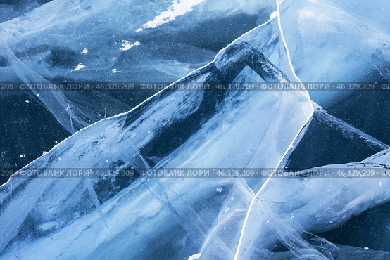 Unique texture of ice. Cold blue ice background with cracks, fracture lines in thickness of ice surface of frozen Baikal Lake in winter day. Top view, close-up, flat lay, mockup, copy space, blank. Стоковое фото, фотограф Виктория Катьянова / Фотобанк Лори