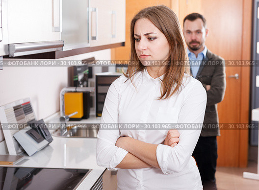 Upset girl with husband in kitchen furniture salon. Стоковое фото, фотограф Яков Филимонов / Фотобанк Лори