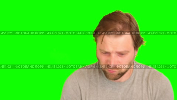 Upset man over plain green background. Adult bearded fun confused shy shamed bemused guy. Green screen chromakey. Handsome sad male looking dissatisfied sadness isolated greenscreen. Expressing sorrow. Стоковое видео, видеограф Марина Демидюк / Фотобанк Лори