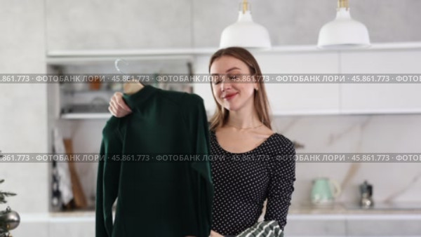 Upset young woman cannot choose a dress for the holiday. Difficult choice. Стоковое видео, видеограф Яков Филимонов / Фотобанк Лори
