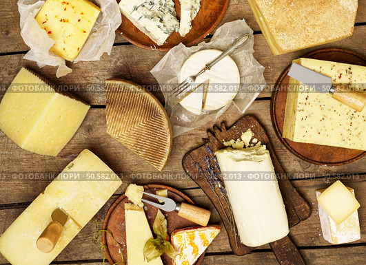 Various types of cheese on rustic background. Стоковое фото, агентство Ingram Publishing / Фотобанк Лори