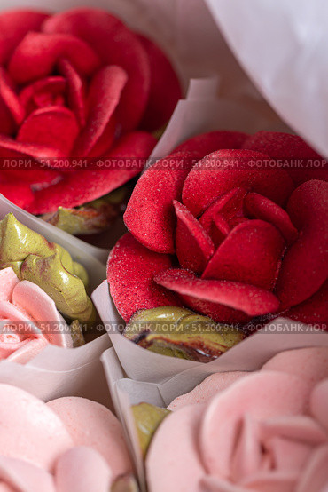 Vibrant home-made zephyr floristry featuring beautifully crafted rose-shaped confections in soft pastel colors, showcasing intricate details and artistic presentation for dessert lovers. Стоковое фото, фотограф Ирина Ручушкина / Фотобанк Лори