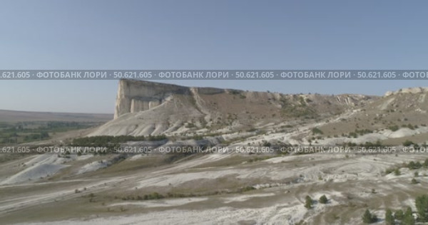 Video from a copter, nature of Crimea, White Rock, trees, roads, summer, blue sky (2022 год). Стоковое видео, видеограф Опока Алексей / Фотобанк Лори