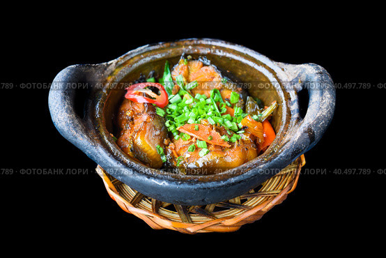 Vietnamese fried Mackerel fish with sauce on black background. Стоковое фото, фотограф Татьяна Терехина / Фотобанк Лори