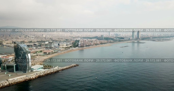View from drone of Barceloneta beach with luxury hotel W Barcelona (2018 год). Стоковое видео, видеограф Яков Филимонов / Фотобанк Лори