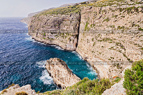 View of rocky clint of northern coast of Malta known as Dingli cliffs (2018 год). Стоковое фото, фотограф Kira_Yan / Фотобанк Лори