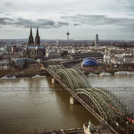 View of the Cologne Cathedral and Hohenzollern Bridge, looking from Koln Triangle tower, Cologne, Germany. View from above. View of the Cologne Cathedral and Hohenzollern Bridge, looking from Koln Triangle tower, Стоковое фото, агентство Ingram Publishing / Фотобанк Лори