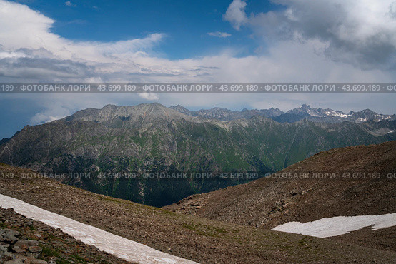 View of the Great Caucasian Ridge opening from the Upper station of the cable car system of the Dombay ski resort on a summer day, Karachay-Cherkessia, Russia. Стоковое фото, фотограф Ula Ulachka / Фотобанк Лори