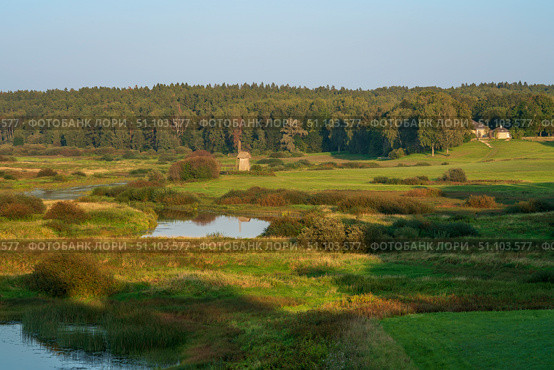 View of the Sorot River valley and an old windmill from Savkina Hill near the Mikhailovskoye estate of the A.S. Pushkin Museum-Reserve on a sunny summer day, Pushkinskiye Gory, Pskov Oblast, Russia. Стоковое фото, фотограф Ula Ulachka / Фотобанк Лори