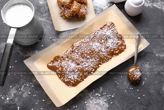 Вкусная соленая карамель с молоком на сером столе. Стоковое фото, фотограф Pixel_shot / Фотобанк Лори