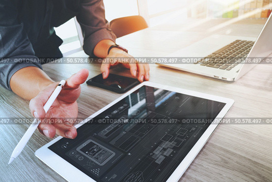 Website designer working digital tablet and computer laptop and digital design diagram on wooden desk as concept. Стоковое фото, агентство Ingram Publishing / Фотобанк Лори