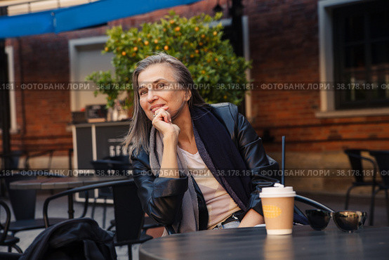 Well-groomed gray-haired woman of 60 years old at cafe table with coffee. Стоковое фото, фотограф Дарья Трофимова / Фотобанк Лори