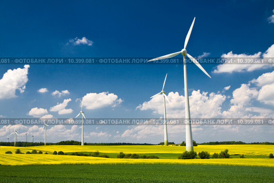Windmills in the fields of yellow rape, renewable energy generators. Стоковое фото, фотограф Artur Wojteczek / PantherMedia / Фотобанк Лори