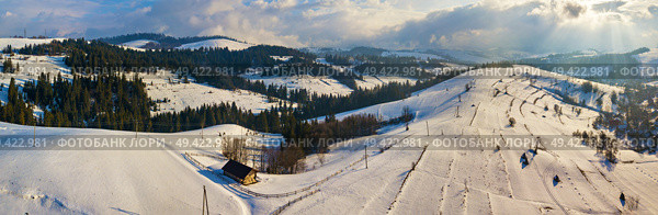 Winter mountain landscape. Panorama of hills and village in Carpathian mountains. Aerial panoramic view. Podobovets and Pilypets villages. Стоковое фото, агентство Ingram Publishing / Фотобанк Лори