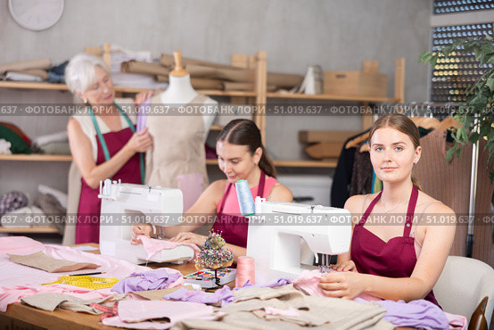 Woman and girl tailors sewing, senior female designer work with mannequin. Стоковое фото, фотограф Яков Филимонов / Фотобанк Лори