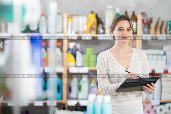 Woman employee with tablet plans to replenish restock stores inventory. Стоковое фото, фотограф Яков Филимонов / Фотобанк Лори
