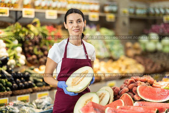 Woman presents melon, best option of vegetables from local and imported producers. Стоковое фото, фотограф Яков Филимонов / Фотобанк Лори