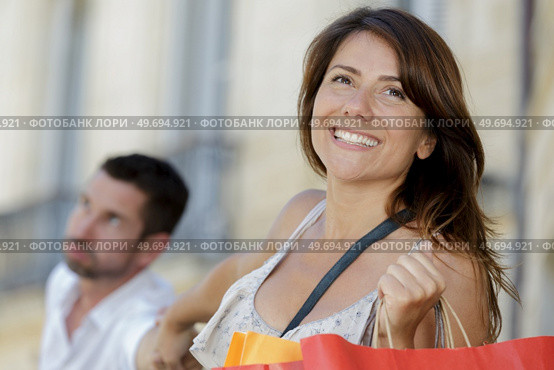 woman pulling her mans hand to continue shopping. Стоковое фото, агентство Ingram Publishing / Фотобанк Лори