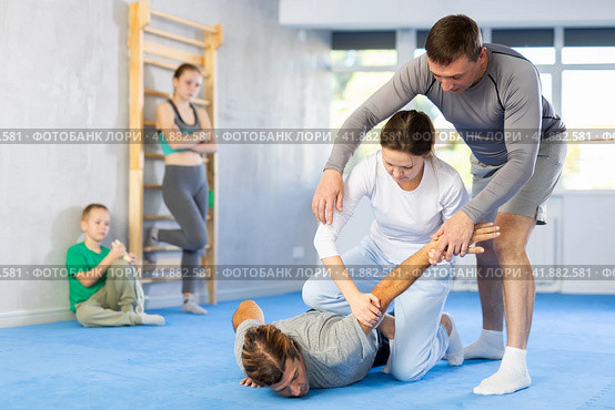 Woman student, with help of male teacher, completes neutralization of opponent. Стоковое фото, фотограф Яков Филимонов / Фотобанк Лори