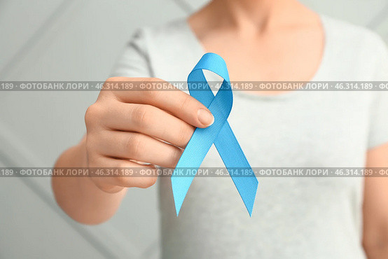 Woman with blue ribbon on grey background, closeup. Prostate cancer awareness concept. Стоковое фото, фотограф Pixel_shot / Фотобанк Лори