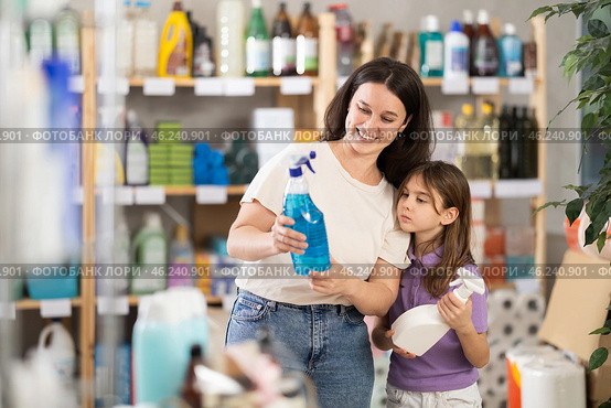 Woman with child family select and studies label multisurface cleaner spray. Стоковое фото, фотограф Яков Филимонов / Фотобанк Лори