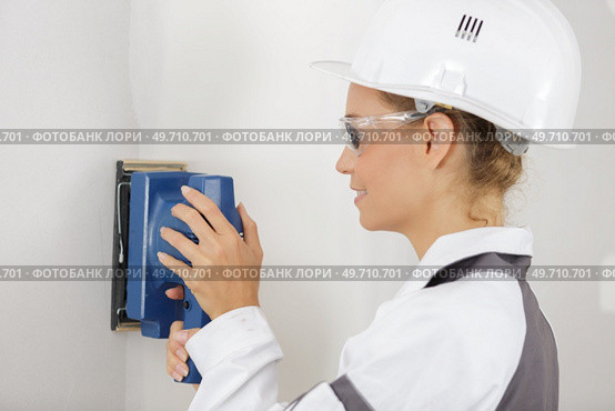 woman worker sanding wall. Стоковое фото, агентство Ingram Publishing / Фотобанк Лори