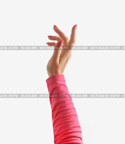 Women hand and invisible something at pale beige background. Backdrop with place for new product. Products merchandise concept. Front view with copy space. Стоковое фото, агентство Ingram Publishing / Фотобанк Лори